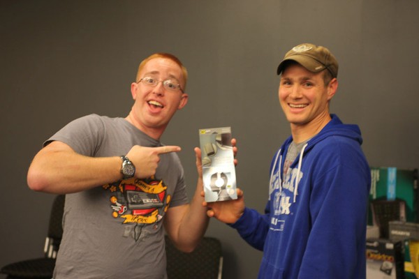 Senior Airman Zachary T. Kerns, USAF (l), SACCS programmer, 55 Strategic Communications Squadron, receives a giveaway from Staff Sgt. Cameron D. Smith, USAF, chapter assistant lead Young AFCEAN. Senior Airman Kerns is just one of the prize recipients who participated in the chapter's October LAN Party.